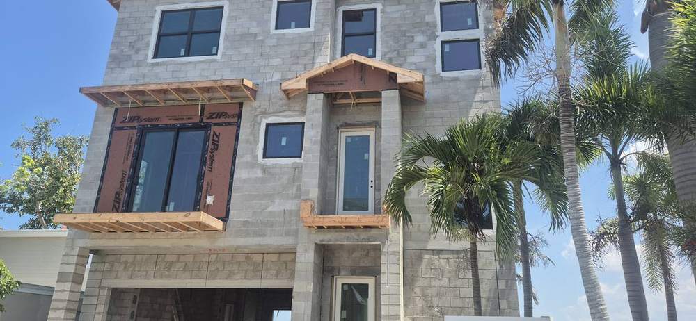 MMATGC framing work — Three-story block shell with framed roof & canopies