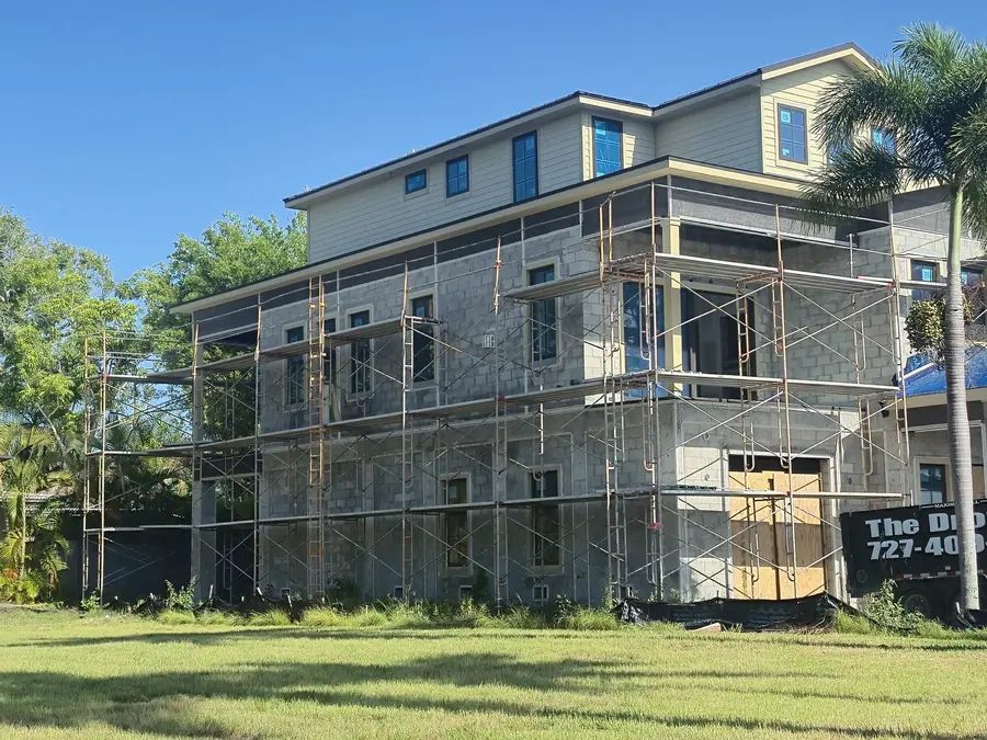 Side view of a custom home under construction by MMATGC in Tampa